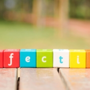 A beautiful colourful picture with wooden cubes in different colours that have a letter on each side. The cubes next to each other spell the word 'effective'